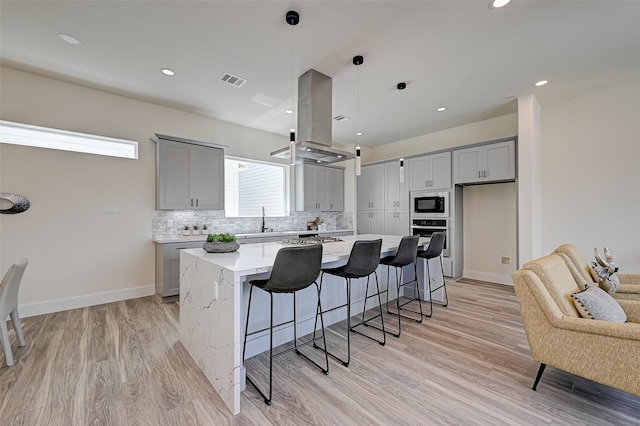 2905 Nagle St, Houston, TX 77004 - kitchen with gray cabinets, appliances with stainless steel finishes, a sink, backsplash, and recessed lighting