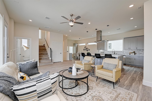 2905 Nagle St, Houston, TX 77004 - living room with a ceiling fan, light wood-style floors, stairs, and recessed lighting
