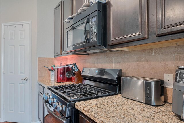 4323 N Vineyard Mdw Ln, Katy, TX 77449 - kitchen featuring gas range, black microwave, tasteful backsplash, dark brown cabinets, and light stone countertops