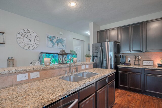 4323 N Vineyard Mdw Ln, Katy, TX 77449 - kitchen with a sink, stainless steel refrigerator with ice dispenser, dark wood-style floors, light stone counters, and a textured ceiling