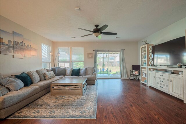 4323 N Vineyard Mdw Ln, Katy, TX 77449 - living area with dark wood-style flooring, a ceiling fan, and a textured ceiling