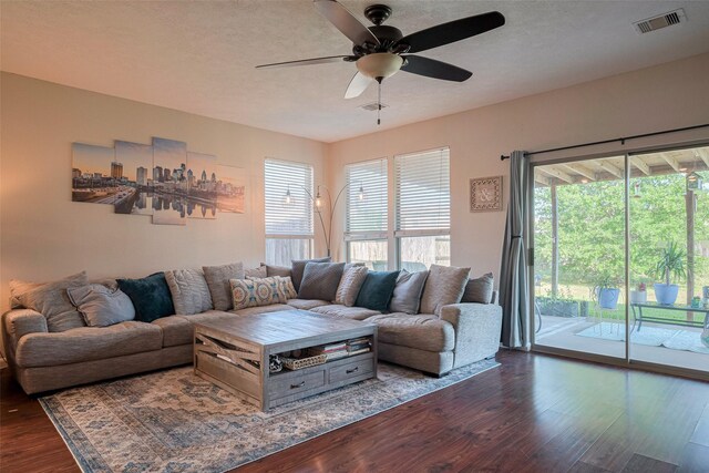 4323 N Vineyard Mdw Ln, Katy, TX 77449 - living area featuring dark wood-style flooring, a ceiling fan, healthy amount of natural light, and a textured ceiling