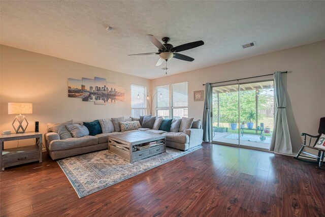 4323 N Vineyard Mdw Ln, Katy, TX 77449 - living area featuring a ceiling fan, dark wood-style flooring, and a textured ceiling
