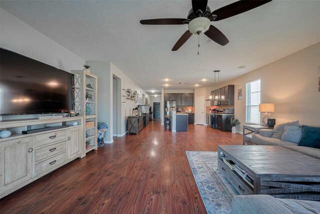 4323 N Vineyard Mdw Ln, Katy, TX 77449 - living room featuring dark wood-type flooring, ceiling fan, baseboards, and recessed lighting
