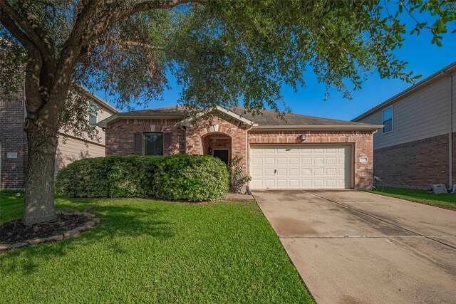 4323 N Vineyard Mdw Ln, Katy, TX 77449 - view of front facade with brick siding, an attached garage, a front lawn, and concrete driveway