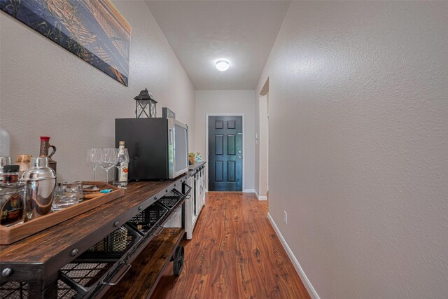 4323 N Vineyard Mdw Ln, Katy, TX 77449 - corridor featuring light wood-type flooring, baseboards, and a textured wall