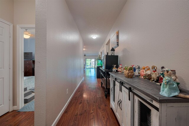 4323 N Vineyard Mdw Ln, Katy, TX 77449 - hall featuring dark wood-style flooring, a textured wall, and baseboards