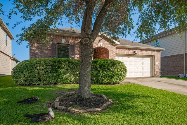 4323 N Vineyard Mdw Ln, Katy, TX 77449 - view of front facade with brick siding, a garage, driveway, and a front lawn