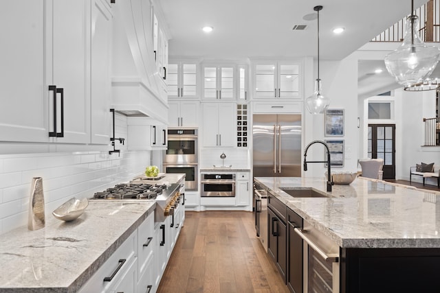 2105 Bennet Ct, Conroe, TX 77384 - kitchen with a sink, appliances with stainless steel finishes, white cabinets, pendant lighting, and recessed lighting
