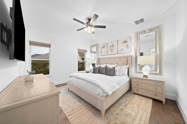 2105 Bennet Ct, Conroe, TX 77384 - bedroom featuring wood finished floors, baseboards, and a ceiling fan