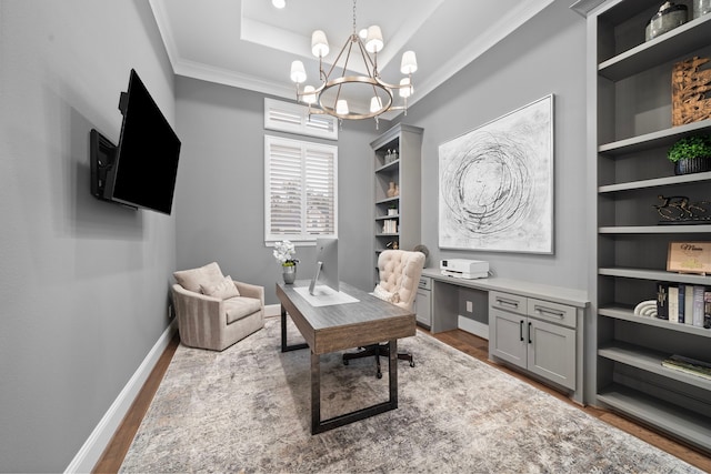 2105 Bennet Ct, Conroe, TX 77384 - office area featuring wood finished floors, a chandelier, ornamental molding, a raised ceiling, and baseboards