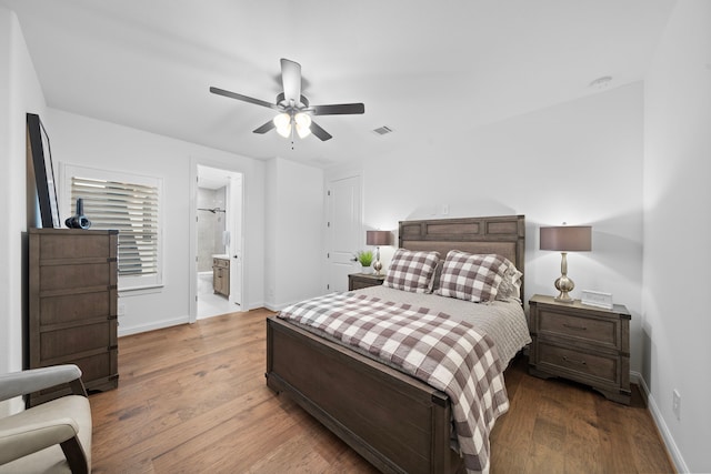 2105 Bennet Ct, Conroe, TX 77384 - bedroom with baseboards, wood finished floors, a ceiling fan, and ensuite bathroom
