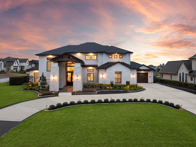 2105 Bennet Ct, Conroe, TX 77384 - view of front facade with driveway, stone siding, a front lawn, and a garage