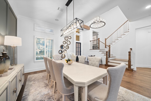 2105 Bennet Ct, Conroe, TX 77384 - dining area featuring dark wood-type flooring, stairway, baseboards, a chandelier, and crown molding
