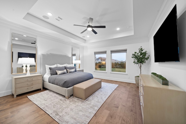 2105 Bennet Ct, Conroe, TX 77384 - bedroom featuring a raised ceiling, light wood-style flooring, baseboards, recessed lighting, and crown molding