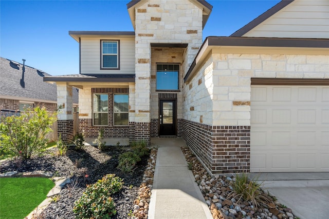 17011 Plover Rock Trl, Hockley, TX 77447 - view of exterior entry featuring a garage and brick siding