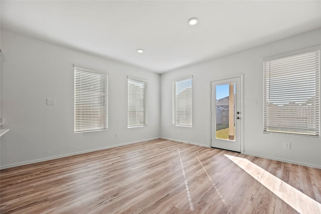 17011 Plover Rock Trl, Hockley, TX 77447 - empty room featuring light wood-type flooring, baseboards, and recessed lighting