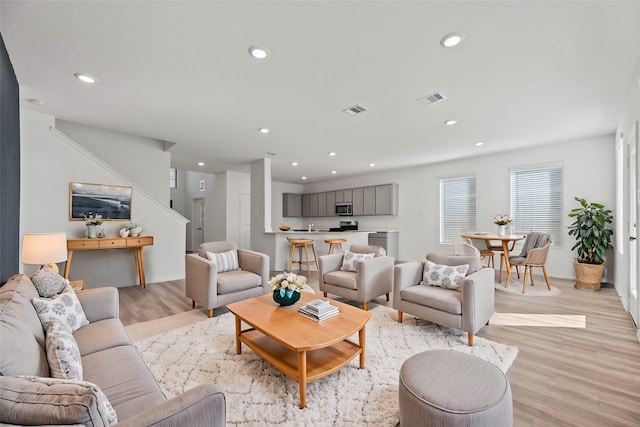 17011 Plover Rock Trl, Hockley, TX 77447 - living area featuring light wood finished floors, recessed lighting, and stairway