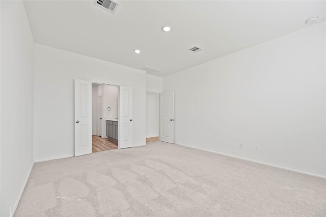 17011 Plover Rock Trl, Hockley, TX 77447 - spare room featuring light colored carpet, baseboards, recessed lighting, and a smoke detector