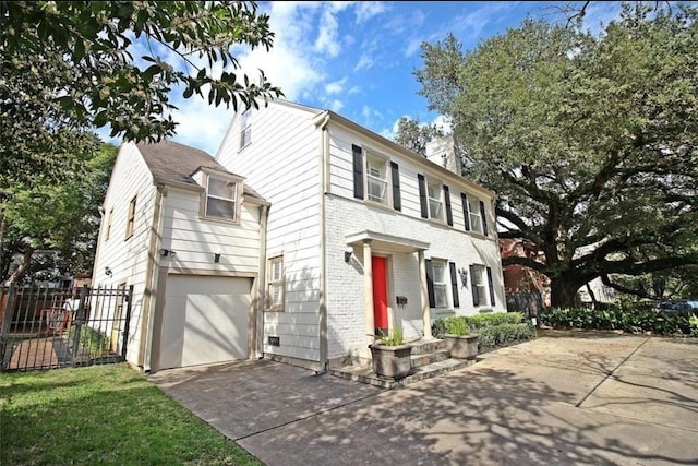 1216 S Shepherd Dr, Houston, TX 77019 - view of front of property with driveway, an attached garage, brick siding, and a chimney