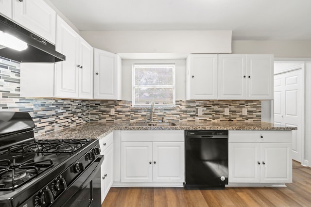 6034 Belmark St, Houston, TX 77033 - kitchen with black appliances, a sink, exhaust hood, light wood-style floors, and decorative backsplash