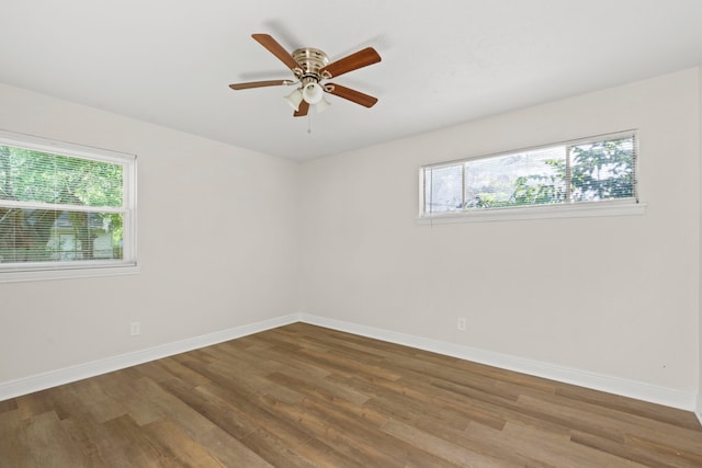 6034 Belmark St, Houston, TX 77033 - spare room with plenty of natural light, wood finished floors, and baseboards