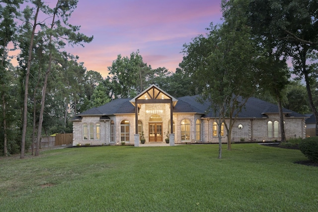 28611 Benders Crossing Dr, Spring, TX 77386 - back of property at dusk featuring brick siding, french doors, and a shingled roof