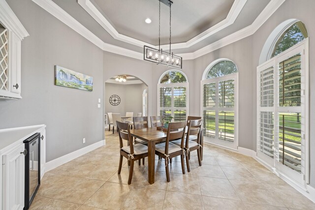 28611 Benders Crossing Dr, Spring, TX 77386 - dining room featuring arched walkways, a raised ceiling, crown molding, healthy amount of natural light, and a chandelier