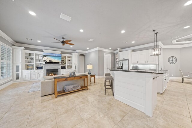 28611 Benders Crossing Dr, Spring, TX 77386 - kitchen featuring dark countertops, light tile patterned floors, crown molding, ceiling fan, and recessed lighting