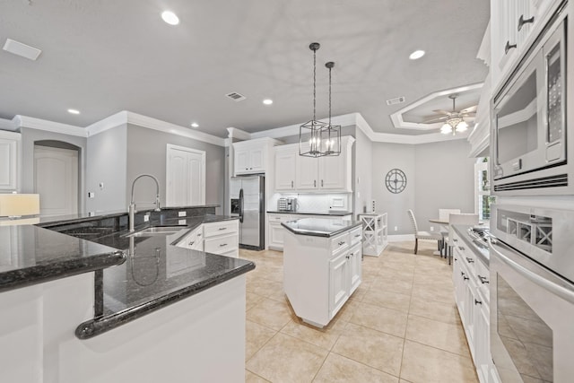 28611 Benders Crossing Dr, Spring, TX 77386 - kitchen with stainless steel appliances, a large island with sink, a sink, ornamental molding, and recessed lighting