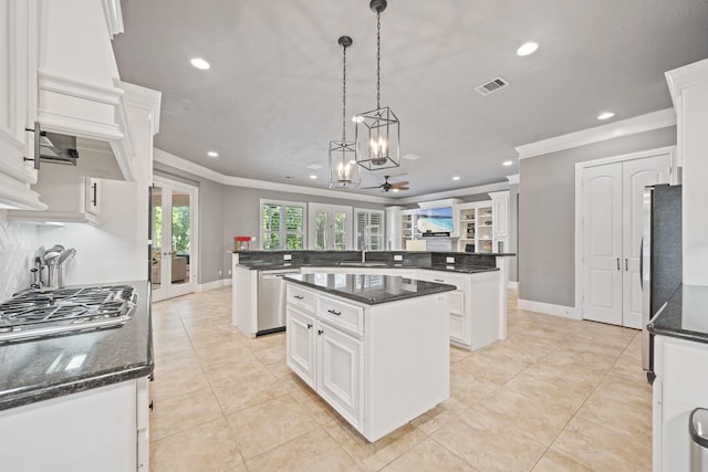 28611 Benders Crossing Dr, Spring, TX 77386 - kitchen with ornamental molding, recessed lighting, a center island, a sink, and appliances with stainless steel finishes