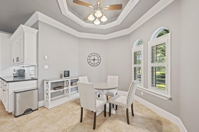 28611 Benders Crossing Dr, Spring, TX 77386 - dining area featuring crown molding, a ceiling fan, light tile patterned floors, a tray ceiling, and baseboards
