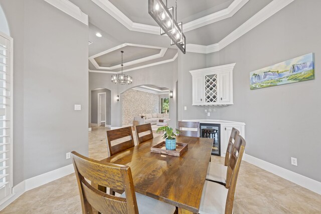 28611 Benders Crossing Dr, Spring, TX 77386 - dining space with a tray ceiling, arched walkways, beverage cooler, ornamental molding, and light tile patterned flooring