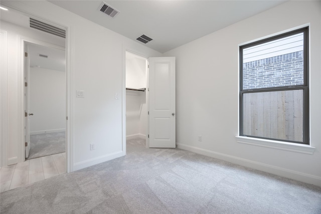 829 Laguna Green Ln, Katy, TX 77493 - unfurnished bedroom with a spacious closet, carpet floors, baseboards, and a closet