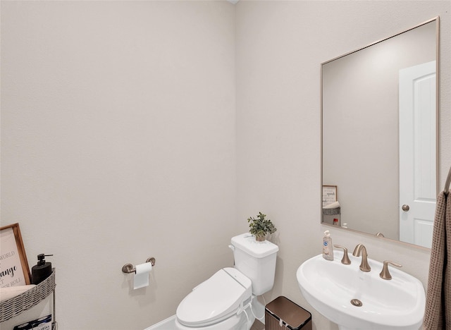 5014 Lillian St, Houston, TX 77007 - half bathroom with a sink, toilet, and baseboards