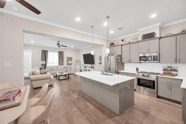 5014 Lillian St, Houston, TX 77007 - kitchen featuring appliances with stainless steel finishes, a ceiling fan, gray cabinets, a sink, and ornamental molding