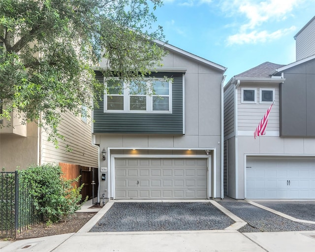 5014 Lillian St, Houston, TX 77007 - view of front of property featuring a garage, stucco siding, and driveway