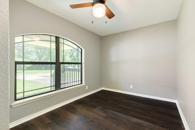 105 Wisteria St, Lake Jackson, TX 77566 - spare room featuring plenty of natural light, dark wood finished floors, baseboards, and a textured wall