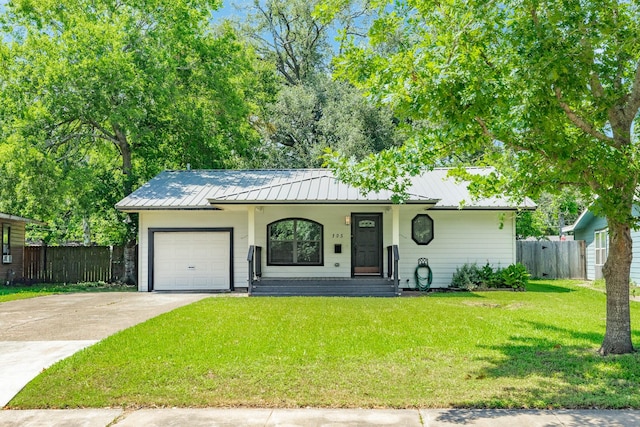 105 Wisteria St, Lake Jackson, TX 77566 - ranch-style house featuring a garage, concrete driveway, covered porch, metal roof, and a standing seam roof