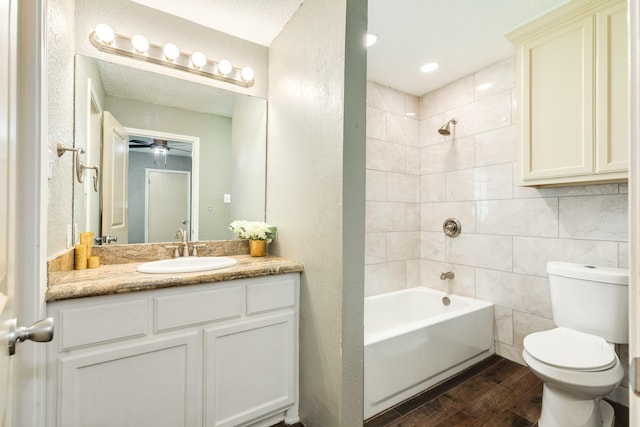 105 Wisteria St, Lake Jackson, TX 77566 - full bath featuring wood finished floors, toilet, vanity, shower / bath combination, and a ceiling fan