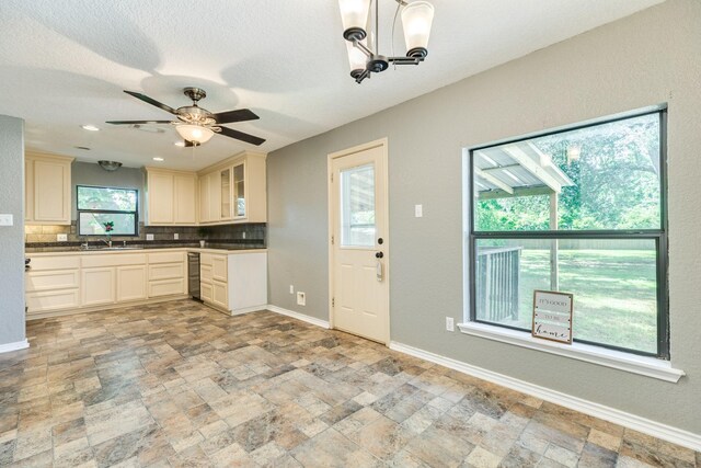 105 Wisteria St, Lake Jackson, TX 77566 - kitchen featuring backsplash, light stone finish flooring, baseboards, and a ceiling fan