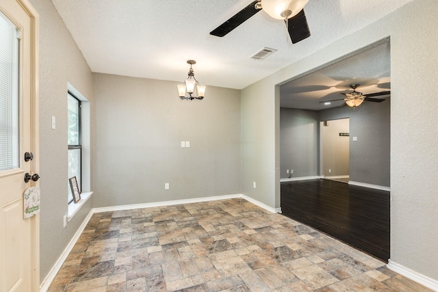 105 Wisteria St, Lake Jackson, TX 77566 - unfurnished room featuring ceiling fan, stone finish flooring, a chandelier, and baseboards