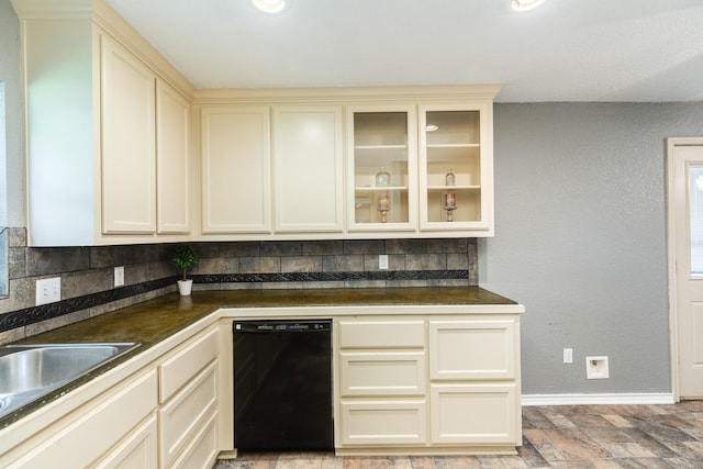 105 Wisteria St, Lake Jackson, TX 77566 - kitchen with black dishwasher, cream cabinetry, decorative backsplash, and dark countertops