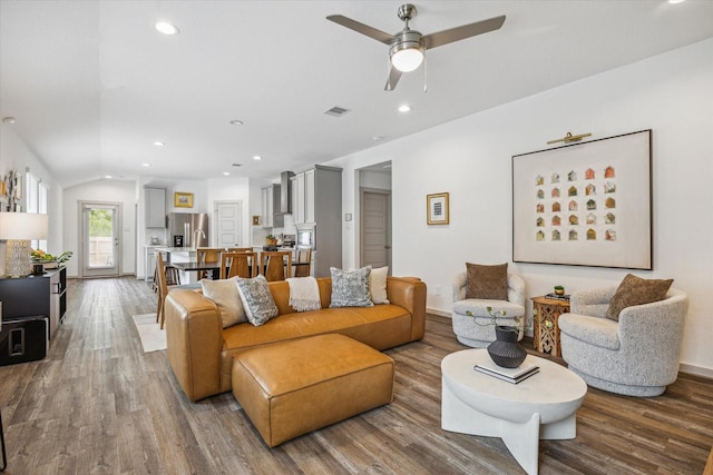 12717 Ermine St, Houston, TX 77047 - living room with wood finished floors, a ceiling fan, recessed lighting, lofted ceiling, and baseboards