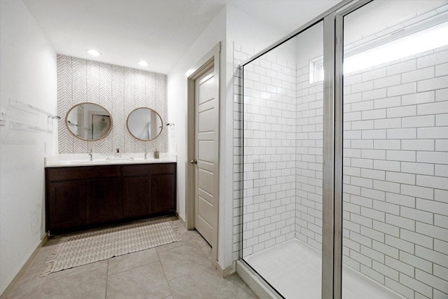 12717 Ermine St, Houston, TX 77047 - bathroom featuring a stall shower, double vanity, recessed lighting, tile patterned floors, and baseboards