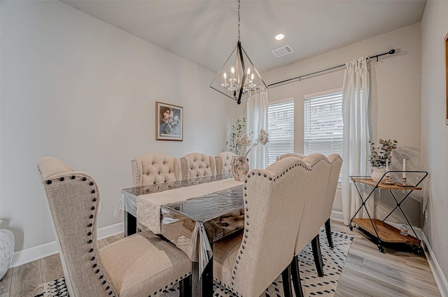 21450 Petherton Dr, Tomball, TX 77375 - dining area featuring a chandelier, baseboards, and light wood-style floors