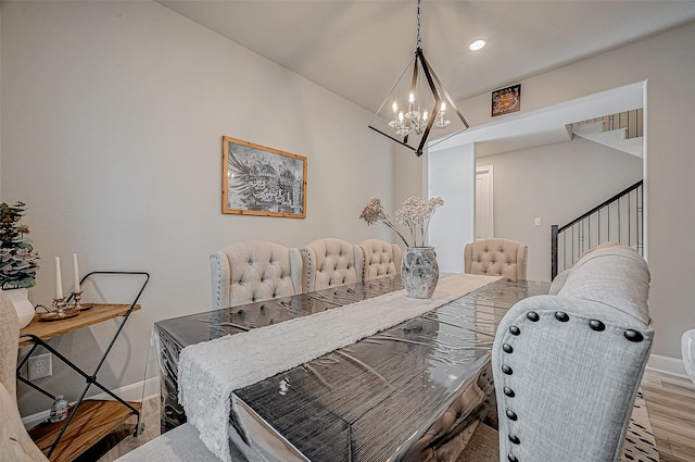 21450 Petherton Dr, Tomball, TX 77375 - dining space with wood finished floors, a chandelier, and baseboards