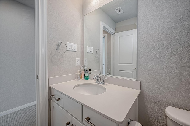 21450 Petherton Dr, Tomball, TX 77375 - half bath with vanity, toilet, and a textured wall