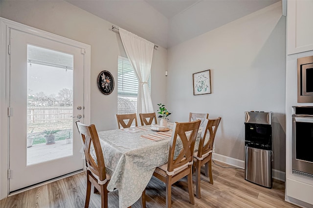 21450 Petherton Dr, Tomball, TX 77375 - dining space featuring light wood-style floors and baseboards