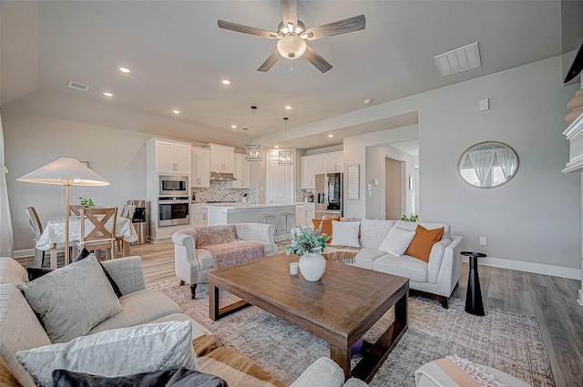21450 Petherton Dr, Tomball, TX 77375 - living room with light wood-style floors, ceiling fan, and baseboards